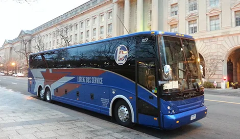 Lorenz Bus Service motorcoach parked on a Washington D.C. street near a large government building