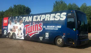 Lorenz charter bus wrapped with Minnesota Twins Fan Express branding parked outdoors