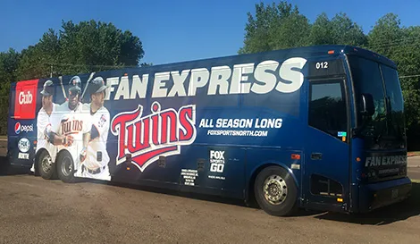 Lorenz charter bus wrapped with Minnesota Twins Fan Express branding parked outdoors
