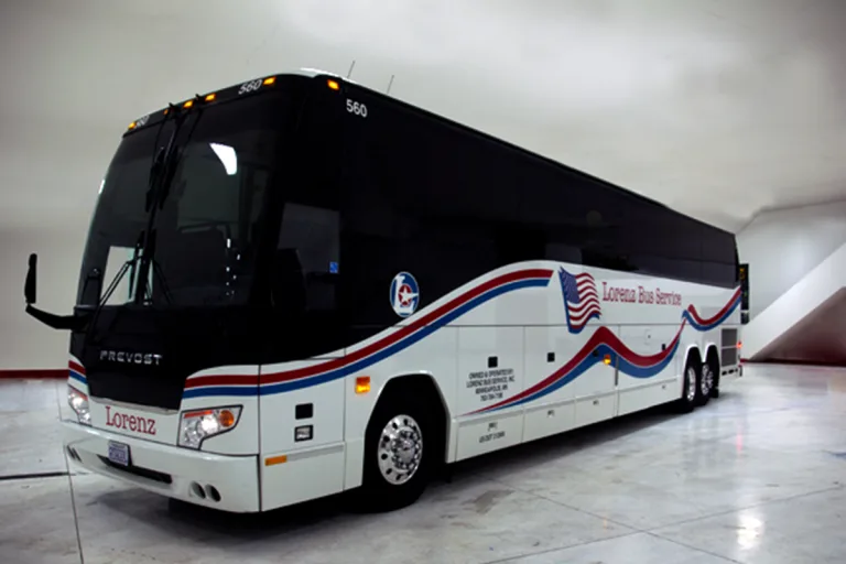 Lorenz Bus Service Prevost motorcoach with red, white, and blue wave livery and American flag graphic