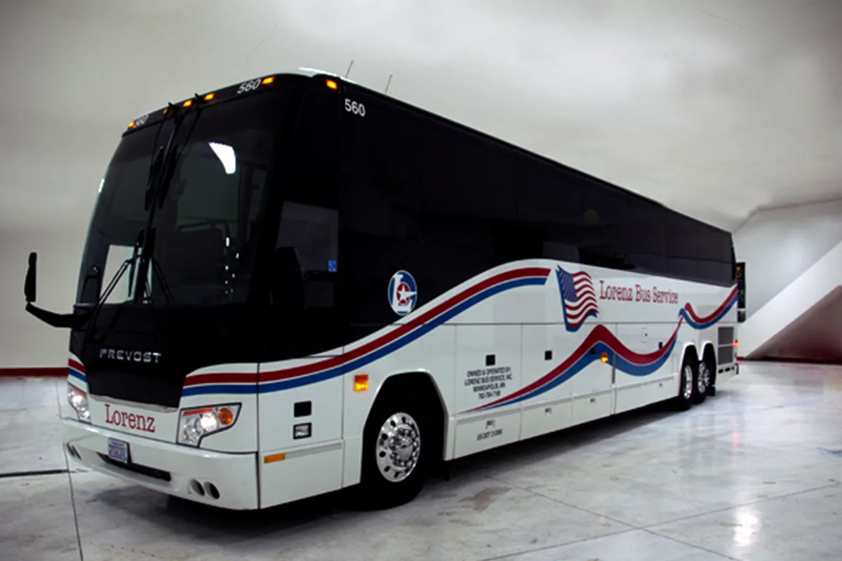 Lorenz Bus Service Prevost motorcoach with red, white, and blue wave livery and American flag graphic