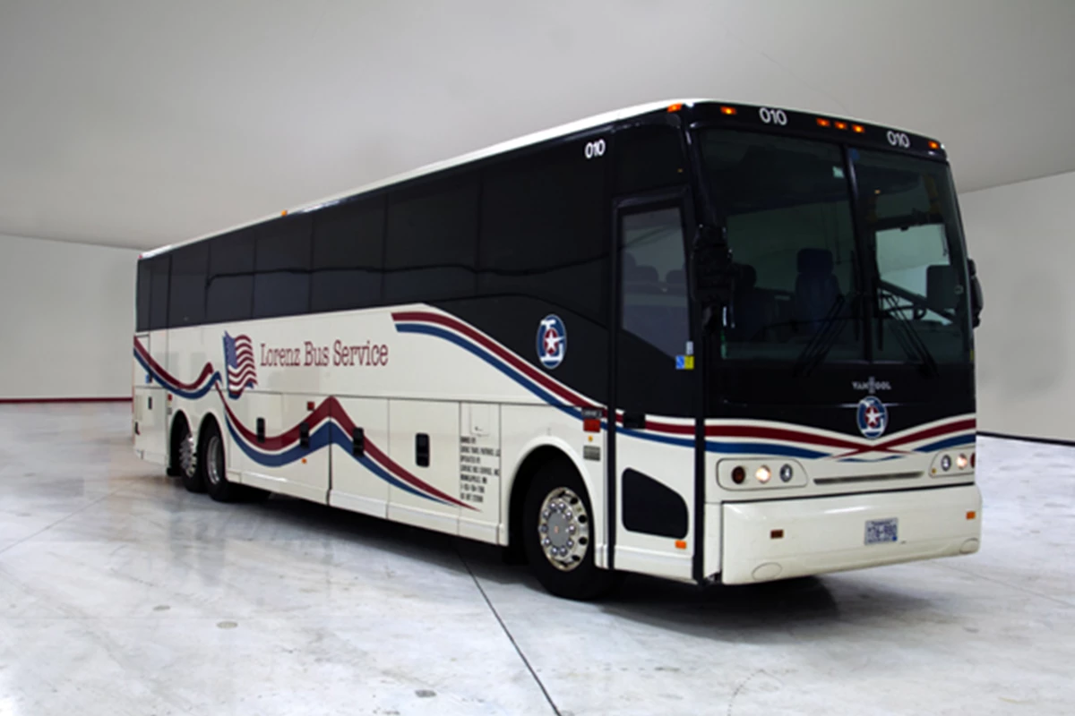 Lorenz Bus Service full-size motorcoach with red, white, and blue wave graphics and American flag logo on the side