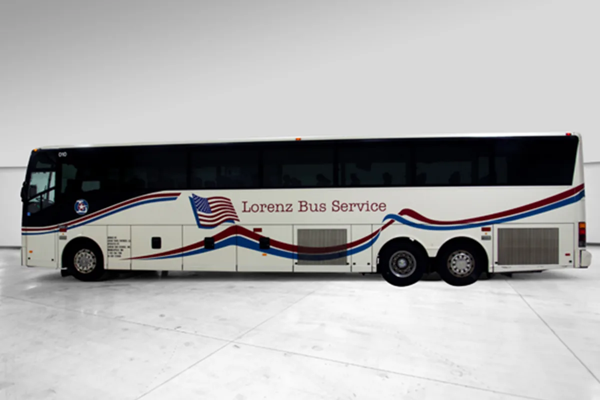 Lorenz Bus Service full-size motorcoach with red, white, and blue livery and American flag graphic