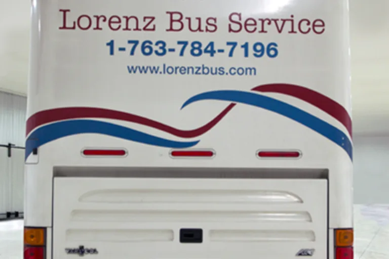Rear of a Lorenz Bus Service coach displaying the company name, phone number 1-763-784-7196, and website www.lorenzbus.com
