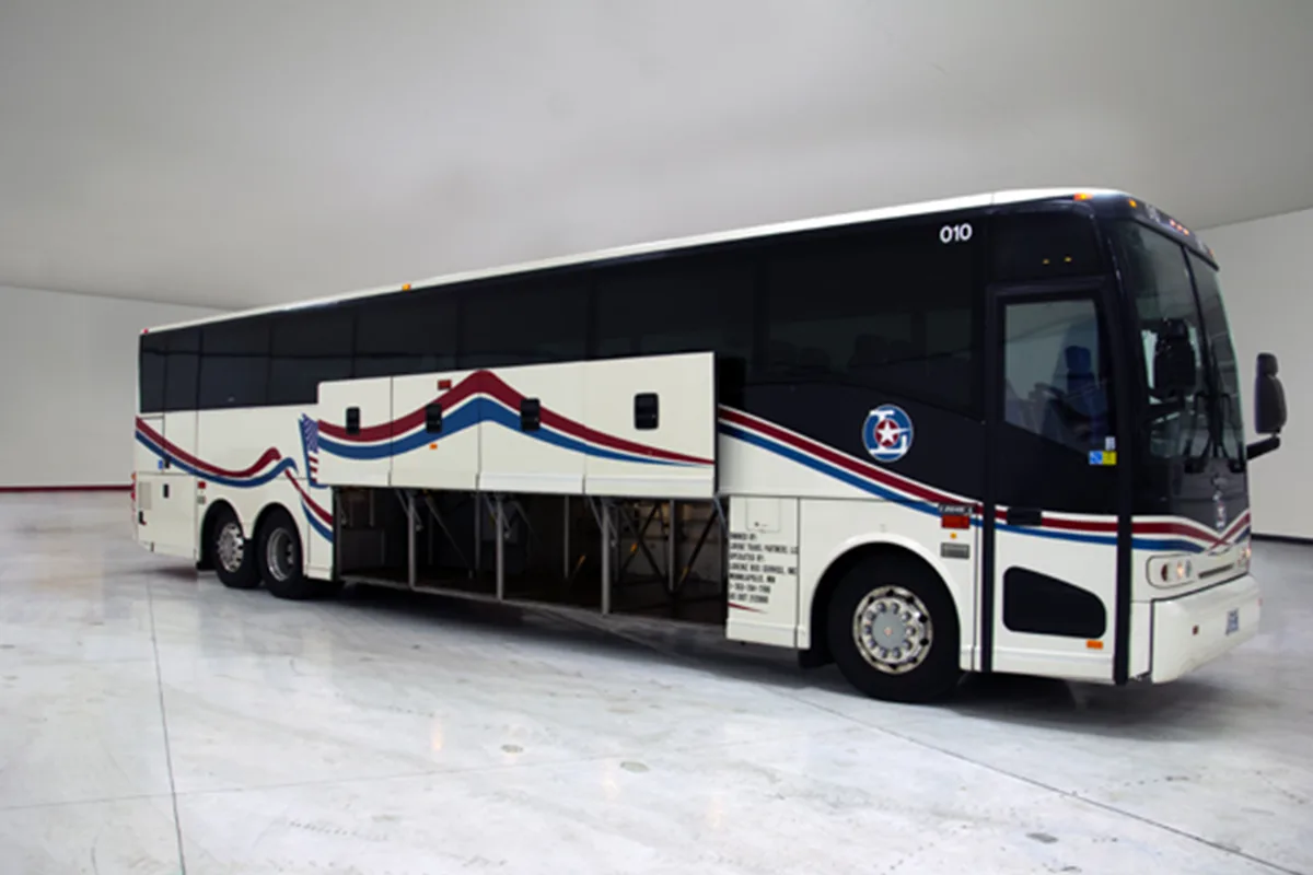Lorenz Bus Service motorcoach with open undercarriage storage bays and red, white, and blue exterior graphics