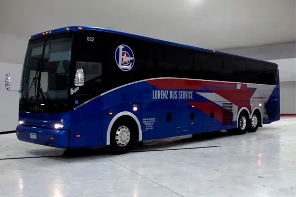 Blue Lorenz Bus Service motorcoach exterior, front three-quarter view parked indoors