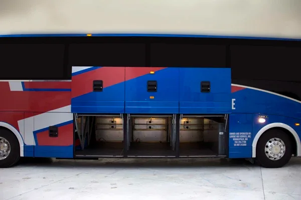 Lorenz Bus Service motorcoach exterior side with luggage bay doors open and bays lit