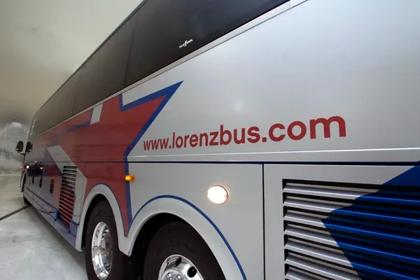 White Lorenz Bus Service motorcoach exterior with lorenzbus.com web address and star graphic