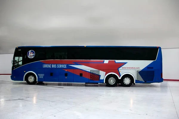 Blue Lorenz Bus Service motorcoach exterior, full side profile parked indoors with star livery
