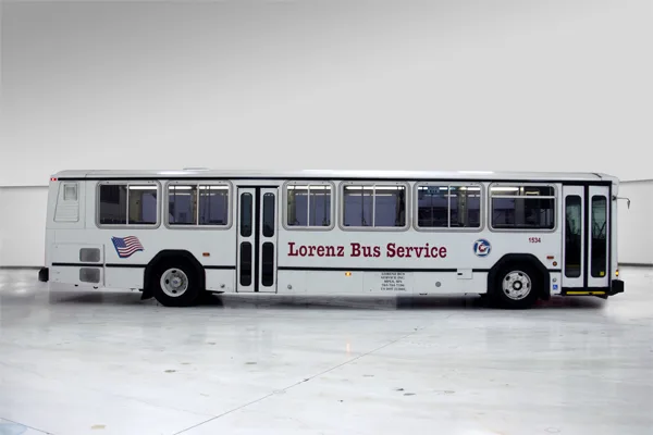 Lorenz Bus Service full-size transit-style bus shown from the side, featuring the company name and American flag logo