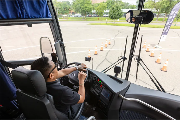 Lorenz Bus Service driver at the wheel navigating a diminishing clearance cone course during safety training