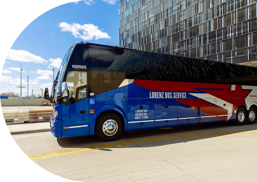 Blue Lorenz Bus Service motorcoach with red and white star graphics parked outside a modern glass building