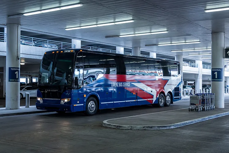 Lorenz Bus Service charter coach staged at an airport Terminal 1 ground transportation area