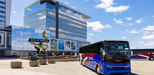 Van Hool motorcoach parked outside Mall of America on a clear day