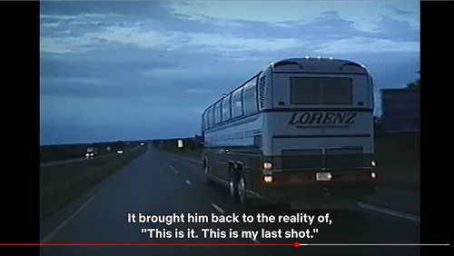 Lorenz motorcoach driving on a highway at dusk in a screenshot from the documentary The Saint of Second Chances