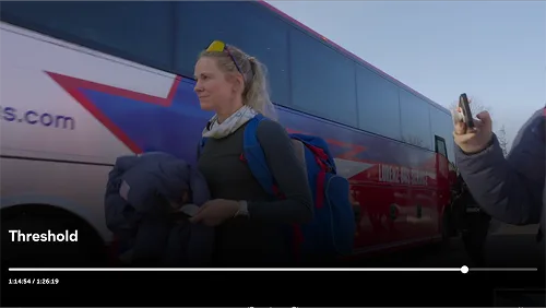 Athlete boarding a Lorenz Bus Service motorcoach in a screenshot from the documentary Threshold: The Untold Story of Jessie Diggins
