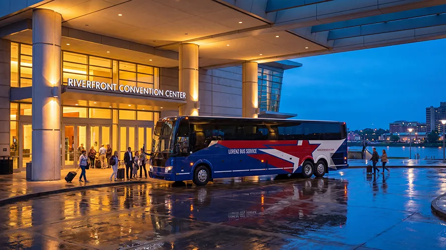 Lorenz Bus Service coach parked at the Riverfront Convention Center entrance at dusk, with passengers boarding