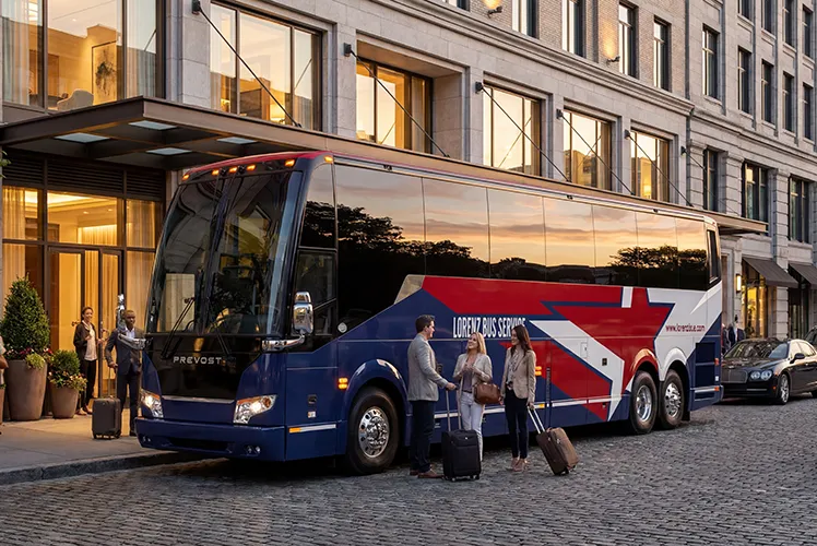 Lorenz Bus Service Prevost motorcoach parked outside a hotel at dusk as passengers with luggage board