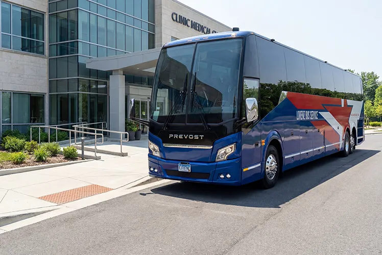 Lorenz Bus Service Prevost motorcoach parked outside a clinic medical center entrance