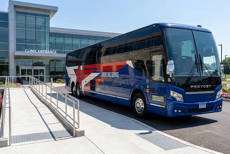 Lorenz Bus Service Prevost motorcoach parked at a clinic entrance, ready for medical or corporate passenger transport