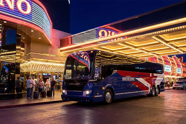 Lorenz Bus Service Prevost motorcoach parked outside a casino at night with passengers boarding