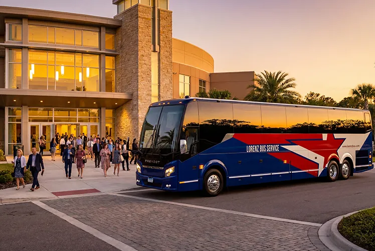 Lorenz Bus Service Prevost charter coach parked outside a venue at sunset as guests exit after an event