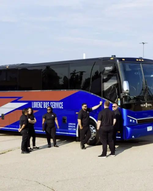 Lorenz Bus Service drivers in uniform gathered outside a branded Van Hool motorcoach